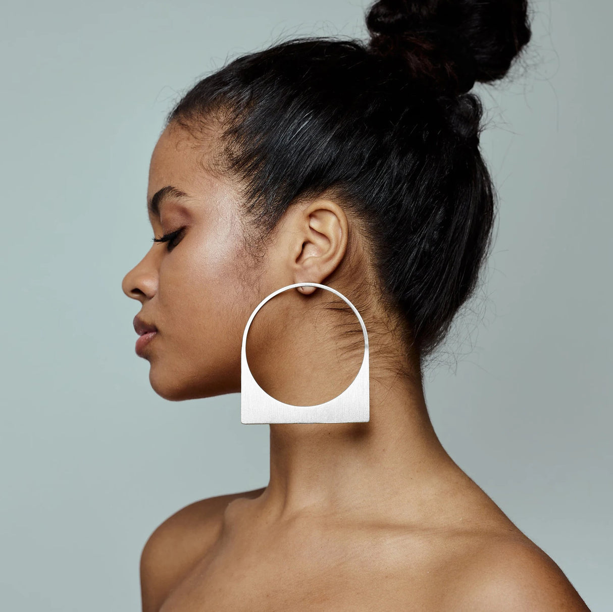 Model using Silver African Large Hoop Earring