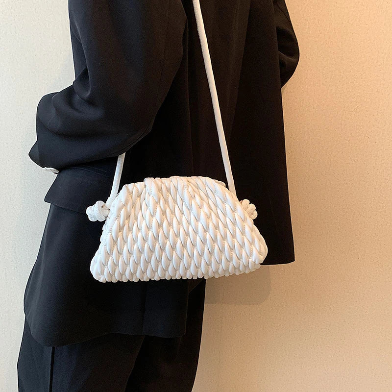 model with white messenger handbag