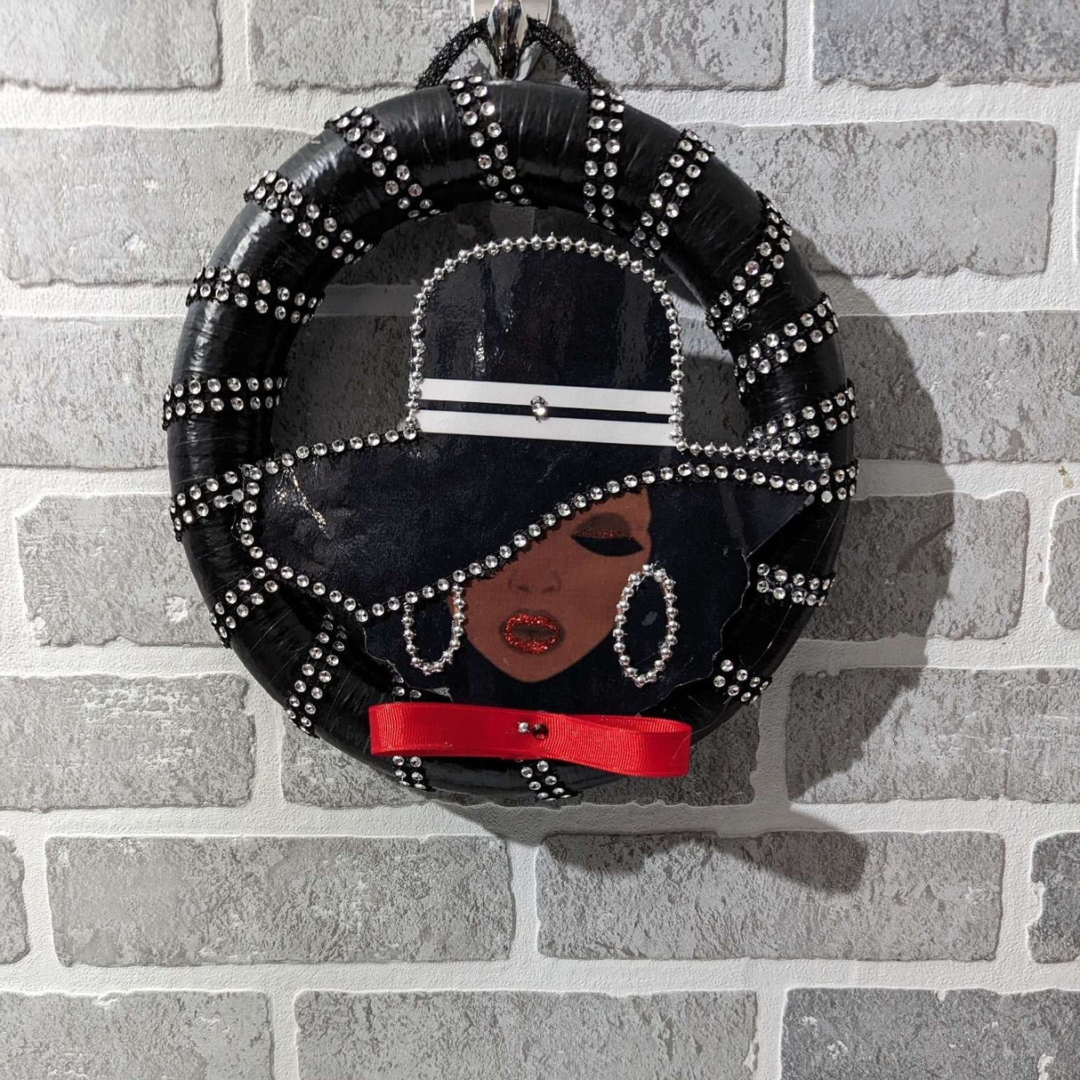 black lady wreath hung in the wall