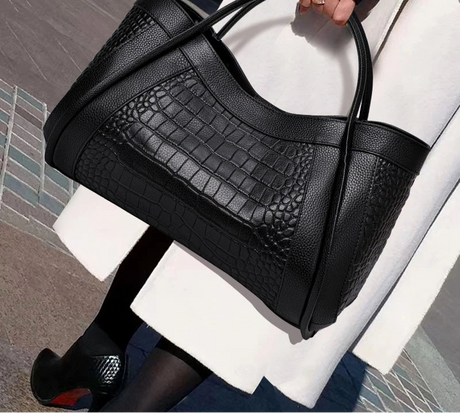 Model using Large Crocodile Pattern Handbag