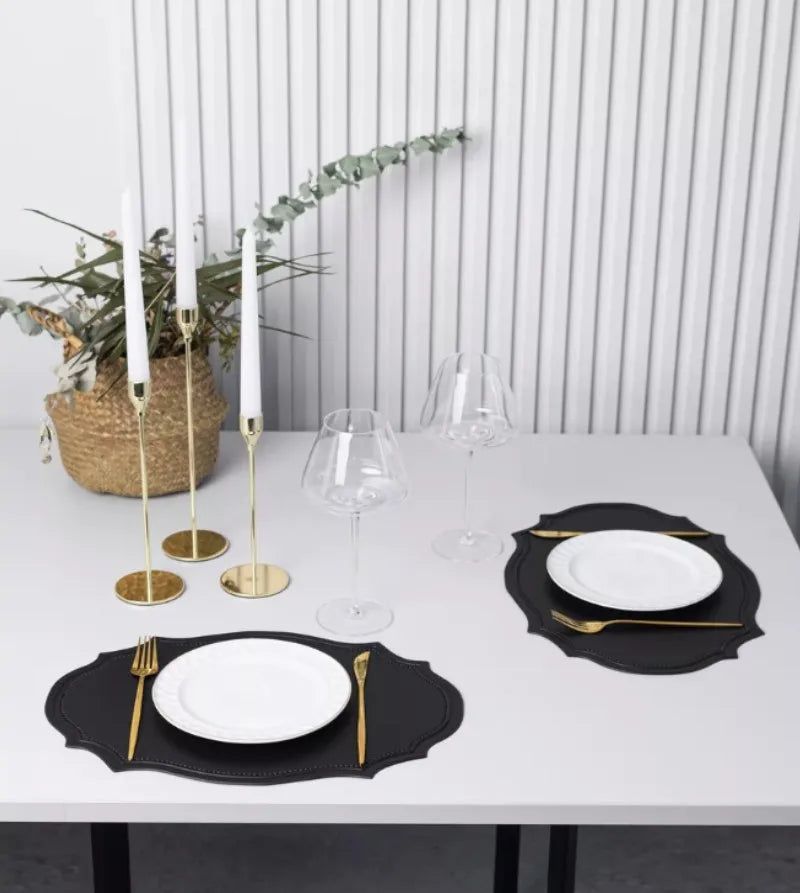 Shaped faux leather PU placemat set in black, pink, and green on a dining table