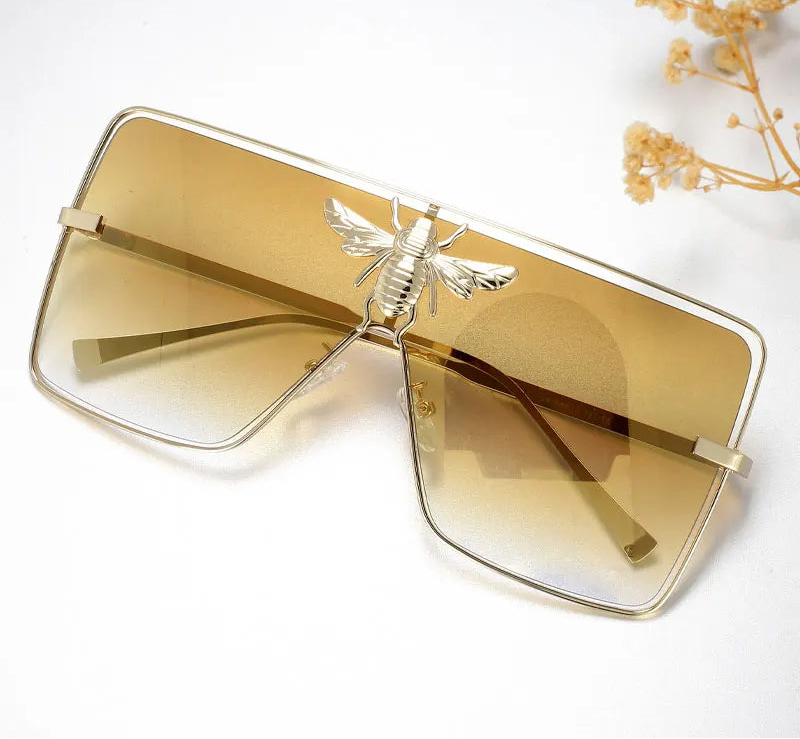 Luxury square metal sunglasses with UV400 protection and bold fashion frame for women.