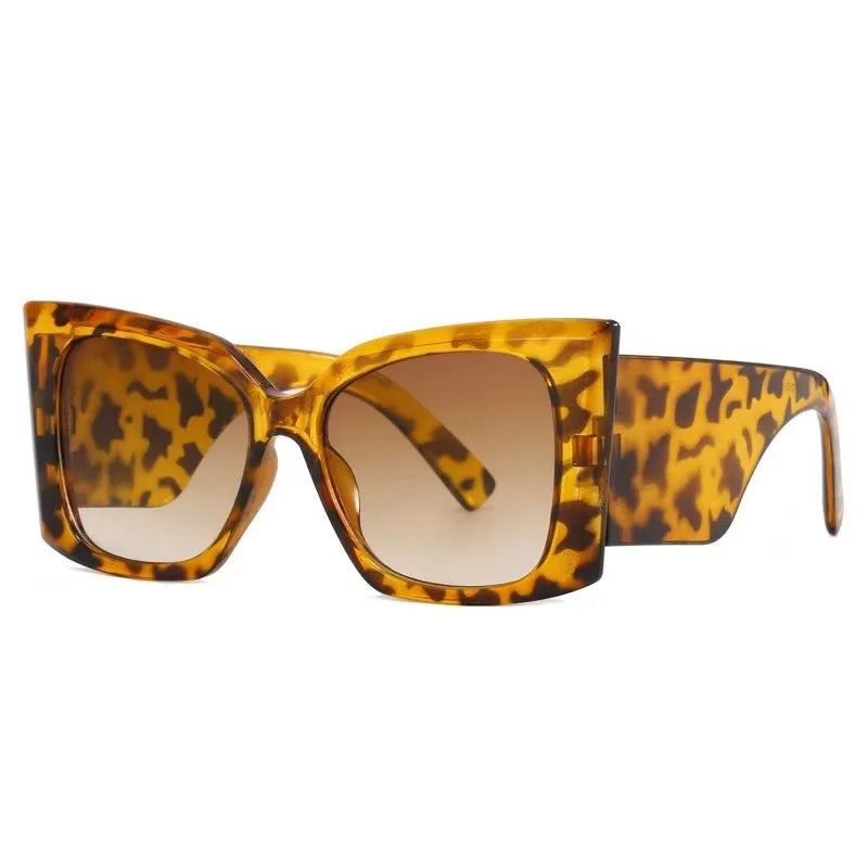 Women’s large cat-eye sunglasses with thick frame design, European-inspired fashion eyewear for outdoor travel and daily wear.