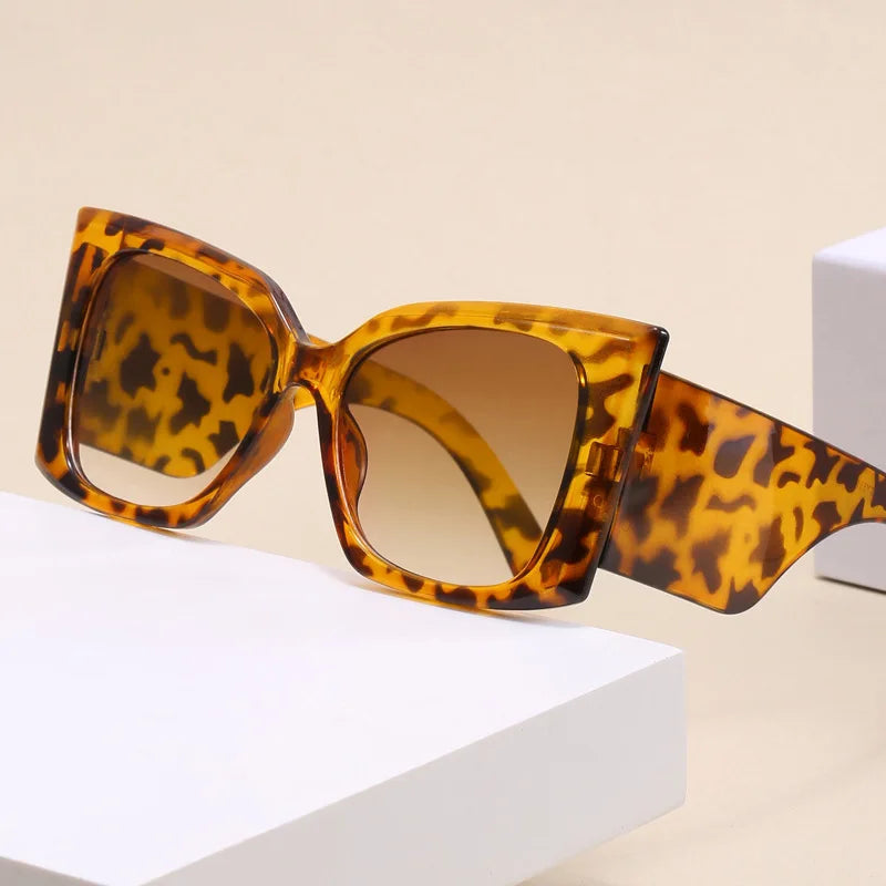 Women’s large cat-eye sunglasses with thick frame design, European-inspired fashion eyewear for outdoor travel and daily wear.