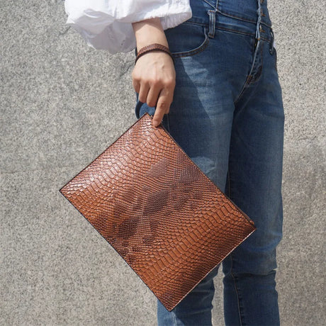 holding python brown handbag