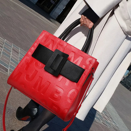 holding red black square handbag