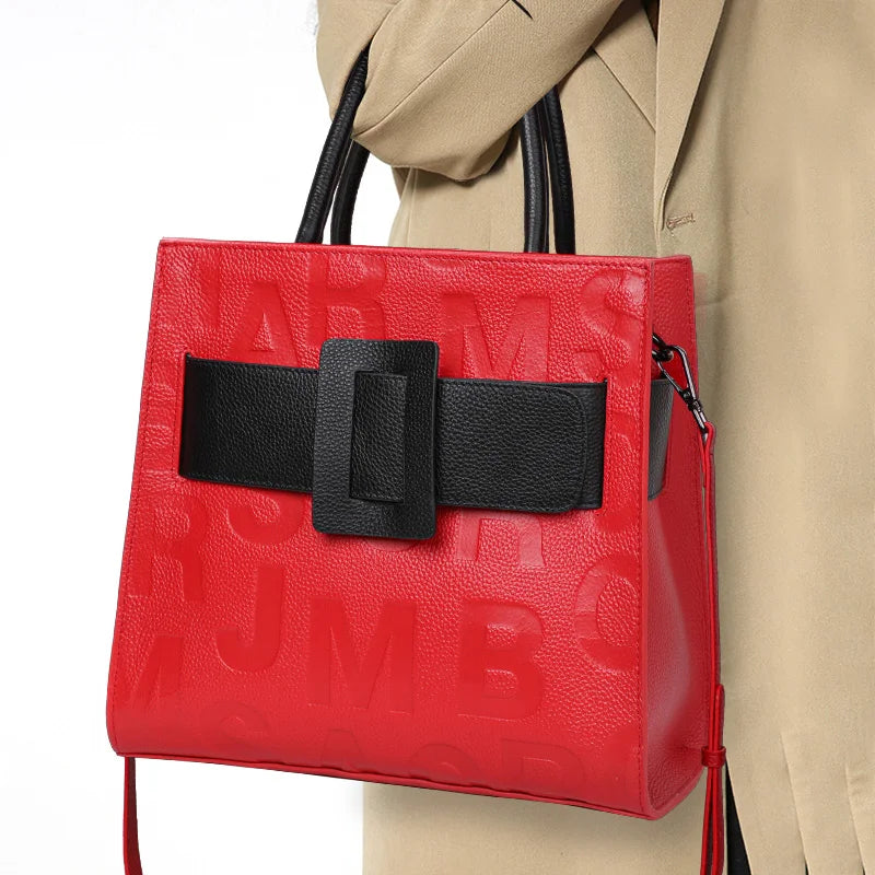 holding red black square handbag