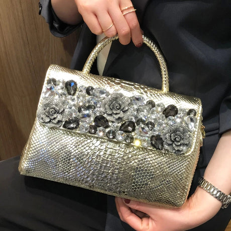 holding gold diamond leather bag