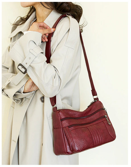 model using red leather handbag