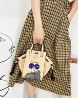 Model using Novelty Lady Face Designer Handbags