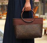 Model holding Rattan Weave Wooden Handbag