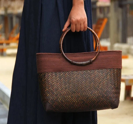 Model holding Rattan Weave Wooden Handbag