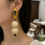 Model Using Vintage-style Niche Beige Resin Beaded Earrings