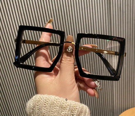 holding black anti blue light glasses 