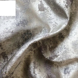 Silver jacquard luxury blackout curtains hanging in a modern living room