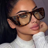 Oversized square jelly color sunglasses with wide frame design and UV400 protection for retro outdoor fashion style.