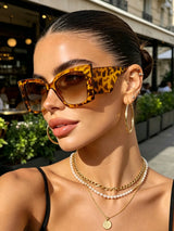 Women’s large cat-eye sunglasses with thick frame design, European-inspired fashion eyewear for outdoor travel and daily wear.