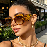 Women’s large cat-eye sunglasses with thick frame design, European-inspired fashion eyewear for outdoor travel and daily wear.