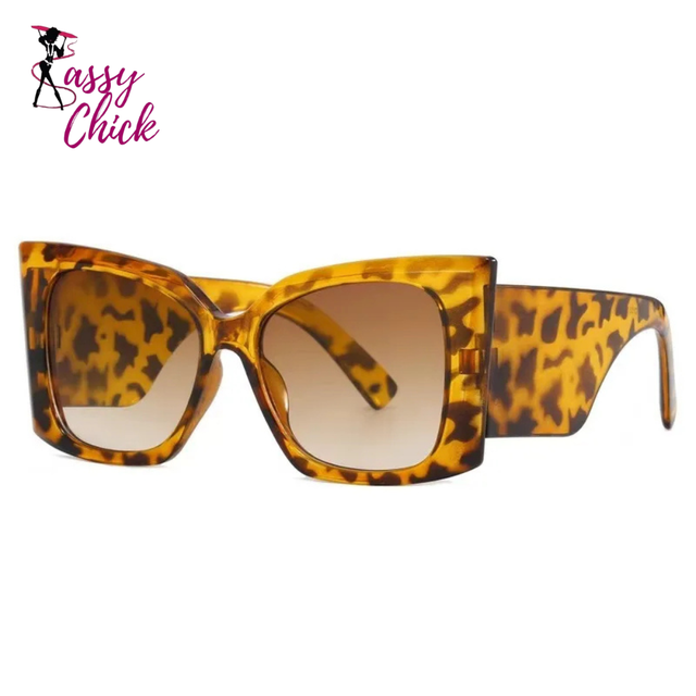 Women’s large cat-eye sunglasses with thick frame design, European-inspired fashion eyewear for outdoor travel and daily wear.