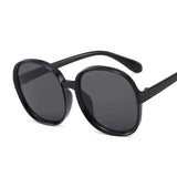 Women’s oversized round vintage sunglasses with plastic frame and luxury designer-inspired style.