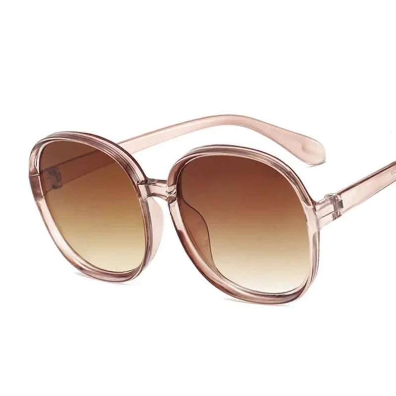 Women’s oversized round vintage sunglasses with plastic frame and luxury designer-inspired style.